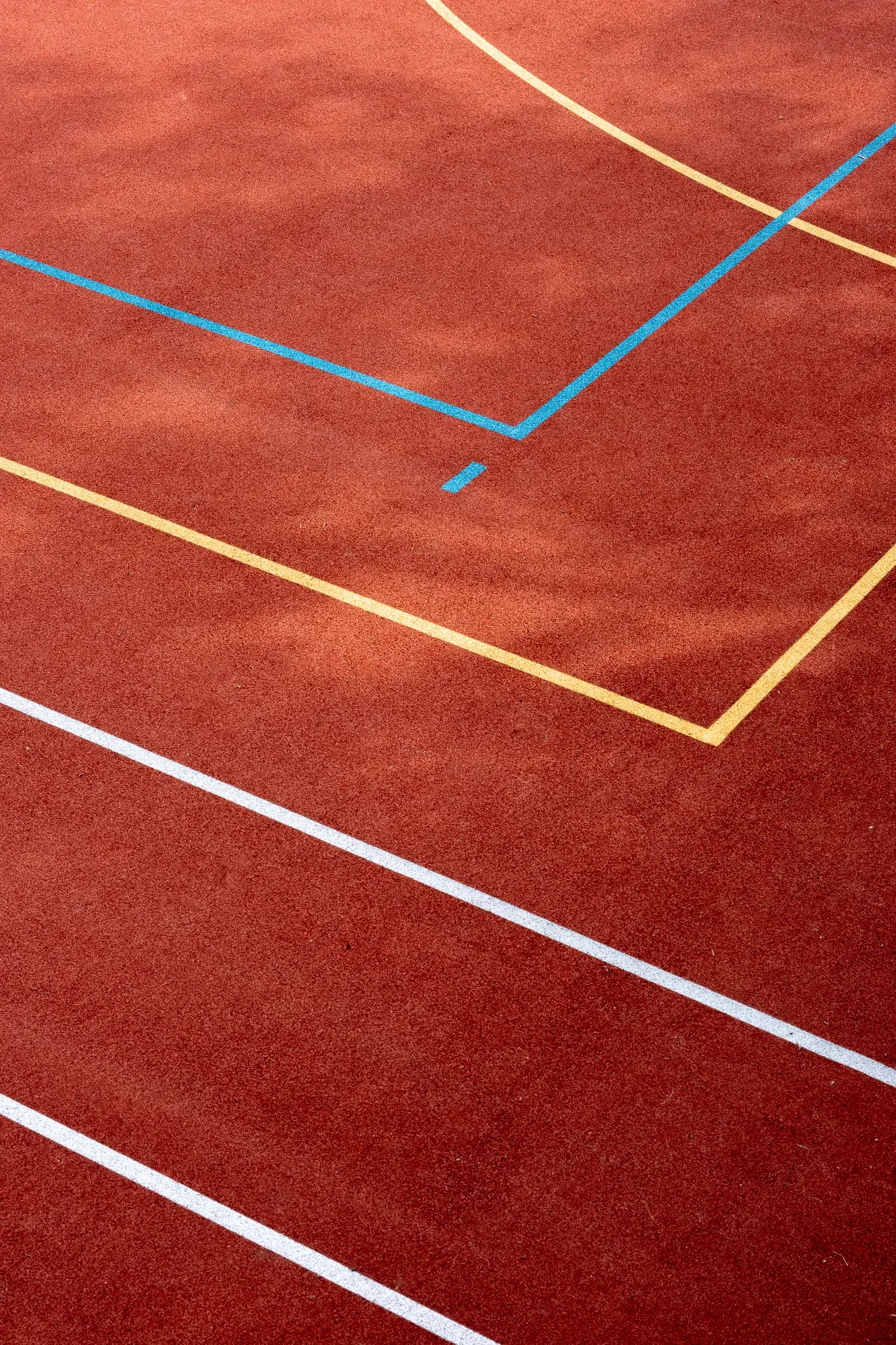Painted lines on a red running track.